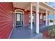 Inviting front porch featuring black framed doors, and columns along the walkway at 14807 Capps Estates Ln, Wimauma, FL 33598