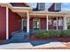 A charming front porch, featuring a beautiful door and neatly manicured landscaping at 14807 Capps Estates Ln, Wimauma, FL 33598