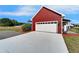 A detached garage with a white door, offering ample parking and additional storage space at 14807 Capps Estates Ln, Wimauma, FL 33598