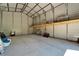 Spacious metal garage with a concrete floor and an overhead storage platform provides ample storage options at 14807 Capps Estates Ln, Wimauma, FL 33598