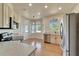 Bright kitchen featuring stainless steel appliances, light countertops and cabinetry, and a breakfast nook at 14807 Capps Estates Ln, Wimauma, FL 33598
