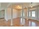 Spacious living room with wood floors, wooden ceiling and a stylish front door at 14807 Capps Estates Ln, Wimauma, FL 33598