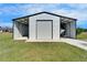 Large, detached outbuilding/barn offers covered parking and ample storage at 14807 Capps Estates Ln, Wimauma, FL 33598