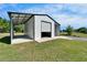 Modern steel outbuilding with attached carport, perfect for storage or a workshop in a serene setting at 14807 Capps Estates Ln, Wimauma, FL 33598