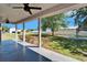 Covered patio view of the home's large backyard, showcasing the wooden gazebo and privacy fence at 14807 Capps Estates Ln, Wimauma, FL 33598