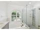 Bright bathroom features a large tub, a glass door shower, and modern finishes at 15018 Greeley Dr, Tampa, FL 33625