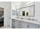 Bright bathroom featuring dual sinks, marble countertops, and modern lighting at 15018 Greeley Dr, Tampa, FL 33625