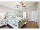 Bedroom showcases a decorative ceiling fan, neutral paint, and wood floors at 15018 Greeley Dr, Tampa, FL 33625