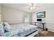 A bright bedroom featuring a sleek desk, natural light, and calming decor at 15018 Greeley Dr, Tampa, FL 33625