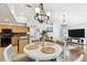 Sunlit dining area adjacent to kitchen with chandelier lighting and view of living room at 15018 Greeley Dr, Tampa, FL 33625