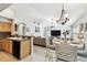Open-concept kitchen and dining area with modern chandelier and views to the living room at 15018 Greeley Dr, Tampa, FL 33625