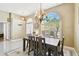 Inviting dining room with decorative chandelier, a large window, and a rustic wood table at 15018 Greeley Dr, Tampa, FL 33625