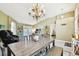 Open dining area with vaulted ceiling, chandelier, and seamless access to backyard oasis at 15018 Greeley Dr, Tampa, FL 33625