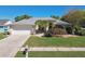 Charming single-story home with a well-manicured lawn, mature trees, and a two car garage at 15018 Greeley Dr, Tampa, FL 33625