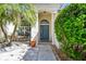 Inviting front entrance with mature landscaping and a bright teal front door with decorative wreath at 15018 Greeley Dr, Tampa, FL 33625