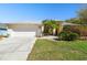 Single-story home includes an attached two-car garage, landscaping, and a well-kept front lawn at 15018 Greeley Dr, Tampa, FL 33625