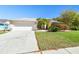 This single-story home includes an attached two-car garage, landscaping, and a well-kept front yard at 15018 Greeley Dr, Tampa, FL 33625