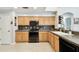 A well-lit kitchen with stainless steel appliances and wood cabinets at 15018 Greeley Dr, Tampa, FL 33625