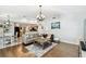 Open-concept living room with wood floors connecting to the dining area at 15018 Greeley Dr, Tampa, FL 33625