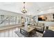 Open-concept living room with hardwood floors, connecting to the dining area at 15018 Greeley Dr, Tampa, FL 33625