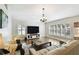 Well-lit living room featuring hardwood floors and shuttered windows at 15018 Greeley Dr, Tampa, FL 33625