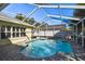 Refreshing screened-in pool featuring a unique kidney shape and a stone paver deck at 15018 Greeley Dr, Tampa, FL 33625