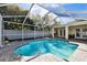 Scenic backyard pool, screened-in, with a paved deck and cozy lounge space at 15018 Greeley Dr, Tampa, FL 33625