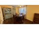 Cozy dining area featuring dark wood table, vintage china cabinet, and hardwood floors for Gathering meals at 1801 Bedford Ln # 46, Sun City Center, FL 33573