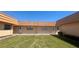 Charming exterior of a single-story home featuring a well-manicured lawn and peach-colored facade at 1801 Bedford Ln # 46, Sun City Center, FL 33573