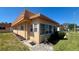 Inviting villa showcasing a sunroom, well-manicured lawn, and a side entrance for added convenience at 1801 Bedford Ln # 46, Sun City Center, FL 33573