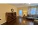 Cozy living room with hardwood floors and a calming atmosphere with a bookshelf and a door at 1801 Bedford Ln # 46, Sun City Center, FL 33573