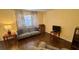 Comfortable living room with hardwood floors, offering a calming retreat with soft lighting and a neutral color palette at 1801 Bedford Ln # 46, Sun City Center, FL 33573