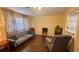 Inviting living room featuring hardwood floors, cozy seating, and natural light from the window at 1801 Bedford Ln # 46, Sun City Center, FL 33573