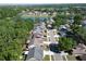 Aerial view showcases the home's location in a neighborhood with lush greenery, close to a scenic lake at 2033 Shadow Pine Dr, Brandon, FL 33511