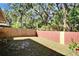 Fenced backyard with lush trees provides a private outdoor retreat with room for recreation and relaxation at 2033 Shadow Pine Dr, Brandon, FL 33511