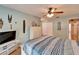 Large bedroom featuring hardwood floors, a queen bed, and large closet at 2033 Shadow Pine Dr, Brandon, FL 33511