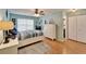 Bedroom featuring hardwood floors, a queen size bed, and natural light from a window at 2033 Shadow Pine Dr, Brandon, FL 33511
