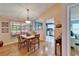 Cozy dining room featuring wood floors and a view into the kitchen with stainless steel appliances at 2033 Shadow Pine Dr, Brandon, FL 33511