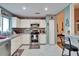 Modern kitchen with stainless steel appliances, white cabinets and access to the dining room at 2033 Shadow Pine Dr, Brandon, FL 33511