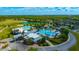 An aerial view showcases the community's clubhouse, multiple pools, tennis courts, and surrounding neighborhood at 21832 Crest Meadow Dr, Land O Lakes, FL 34637