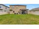 Expansive backyard with lush lawn, fenced perimeter, and a screened-in patio for outdoor relaxation at 21832 Crest Meadow Dr, Land O Lakes, FL 34637