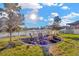 Picturesque backyard with a waterfront view, a fire pit, seating, and a white fence at 21832 Crest Meadow Dr, Land O Lakes, FL 34637