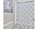 Nautical themed bathroom with white anchor shower curtain and gray octopus art on wall at 21832 Crest Meadow Dr, Land O Lakes, FL 34637