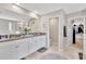 Bathroom with double vanity, granite countertop and access to water closet and walk-in closet at 21832 Crest Meadow Dr, Land O Lakes, FL 34637