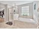 Bathroom featuring a large soaking tub, separate shower, and window with natural light at 21832 Crest Meadow Dr, Land O Lakes, FL 34637
