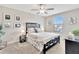 Bedroom with black grid headboard, ceiling fan, and matching furniture set at 21832 Crest Meadow Dr, Land O Lakes, FL 34637