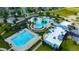 An aerial view showcases the community's pool area, palm trees, lounge chairs, and pool at 21832 Crest Meadow Dr, Land O Lakes, FL 34637