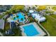 Aerial view of the community's pool area, palm trees, lounge chairs, and pool at 21832 Crest Meadow Dr, Land O Lakes, FL 34637