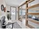 Inviting entryway with a bench seat, decorative mirror, front door, and sliding glass doors to the office at 21832 Crest Meadow Dr, Land O Lakes, FL 34637