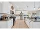 Modern kitchen with white cabinets, granite countertops, stainless steel appliances, and neutral tile flooring at 21832 Crest Meadow Dr, Land O Lakes, FL 34637